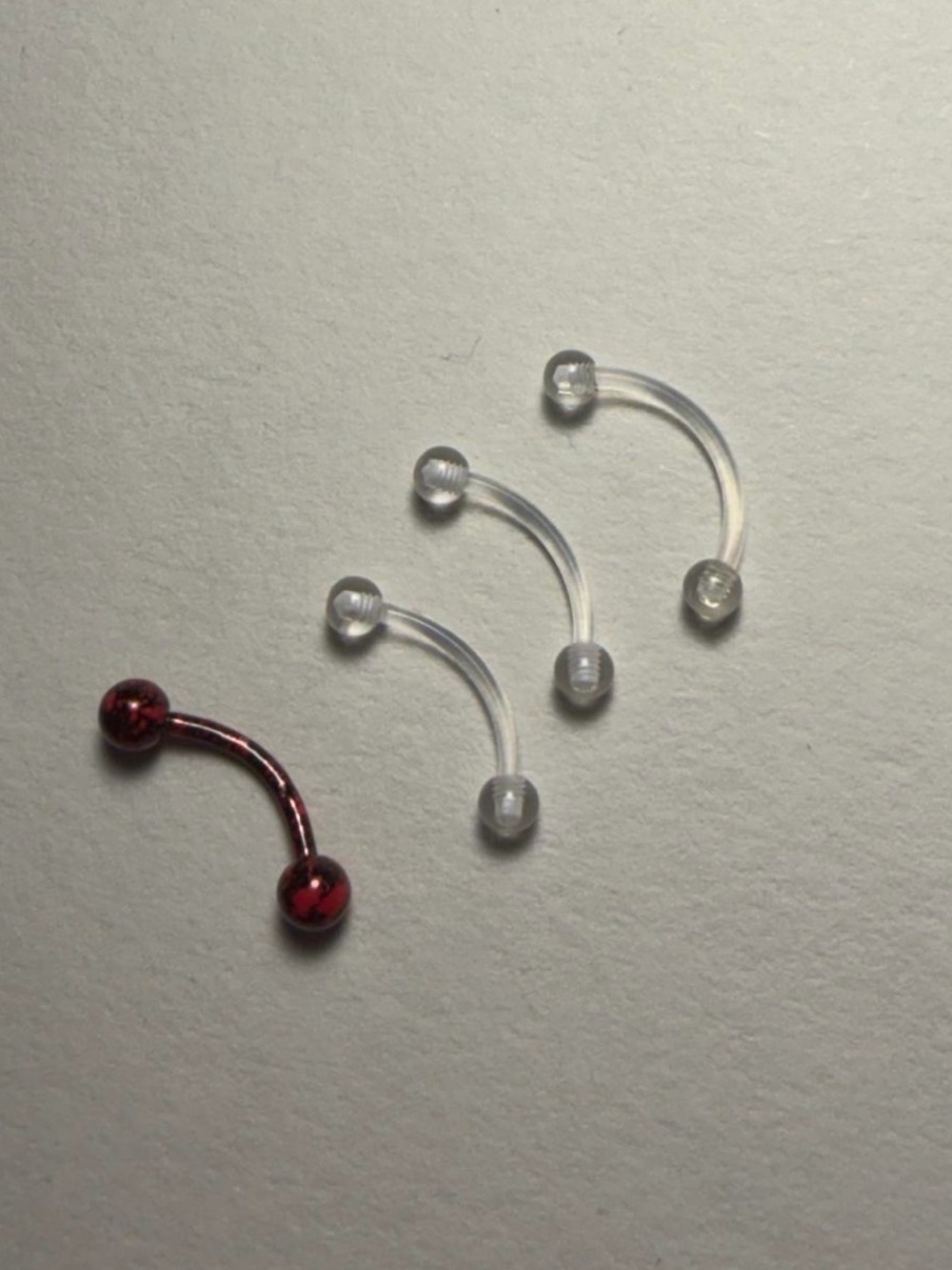 Spencer's Clear and Red Curved Eyebrow Rings - 4 Pack